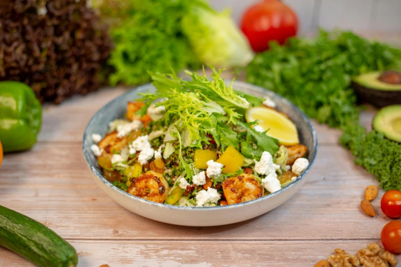 the bowl of vegetables has chicken, tomatoes and broccoli in it