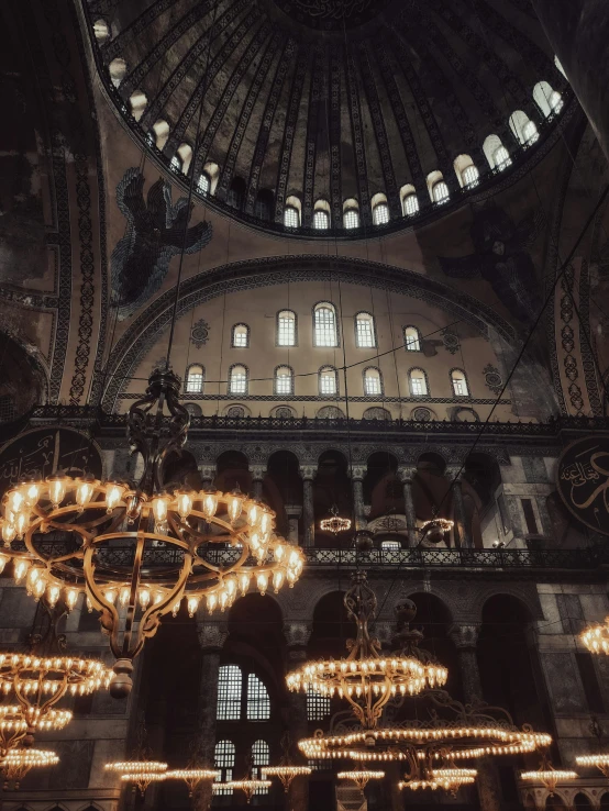 chandelier lights hang from the ceiling of a church