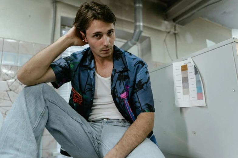 a man is sitting on the bottom of an old refrigerator