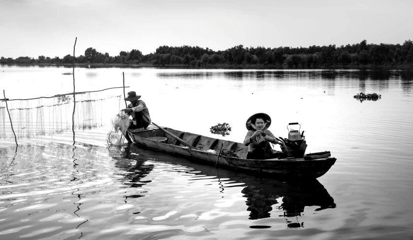 two people riding in a small boat on the water