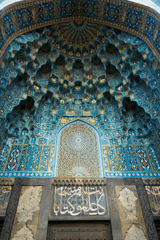 ornate blue and gold building with intricate paintings on the wall