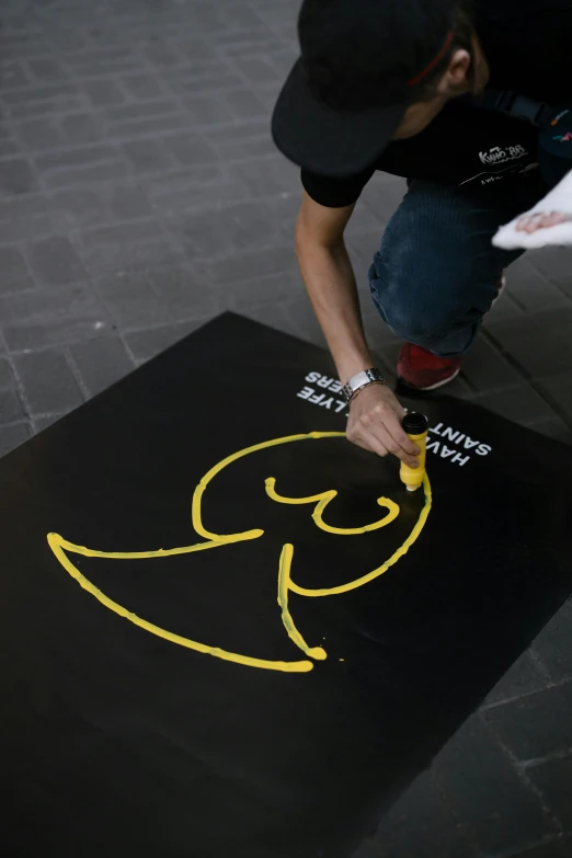 a man is drawing on the black area rug