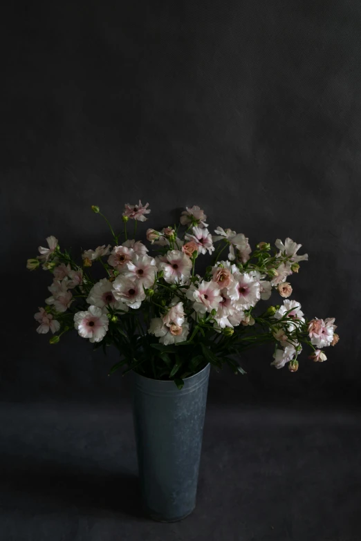 an arrangement of white and pink flowers in a vase