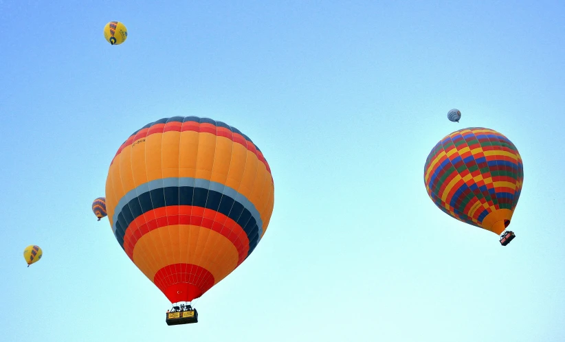 several different balloons floating in the air together