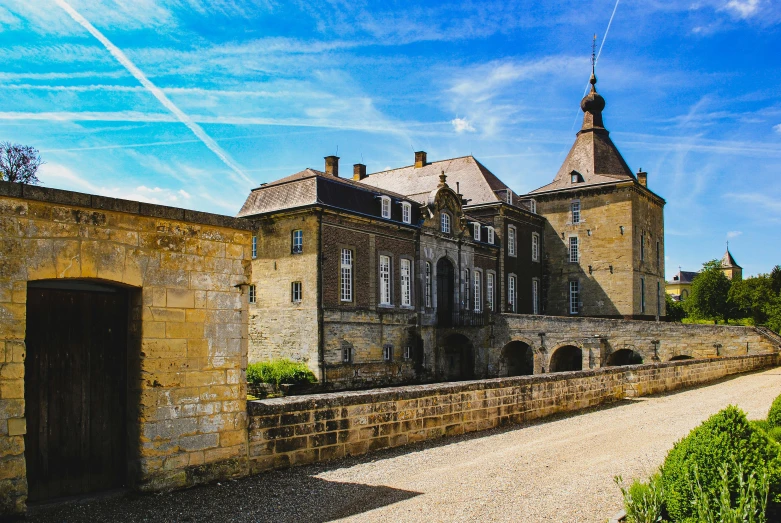 a big building sitting next to a large brick wall