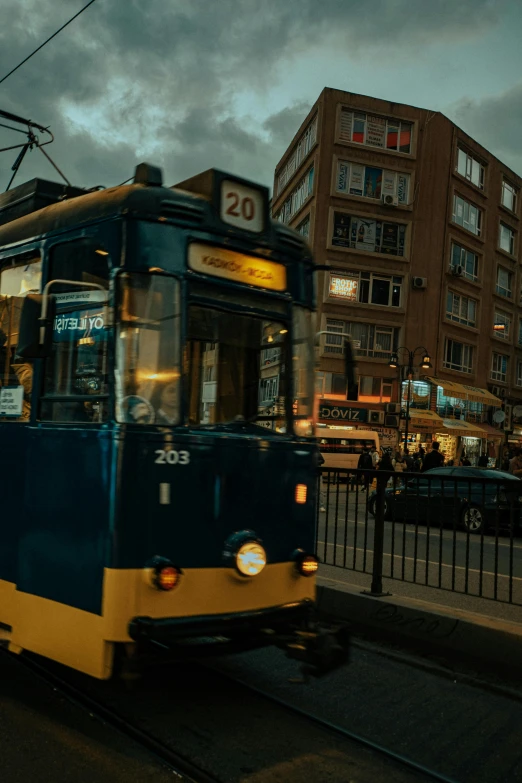 a blue and yellow bus is driving down the street