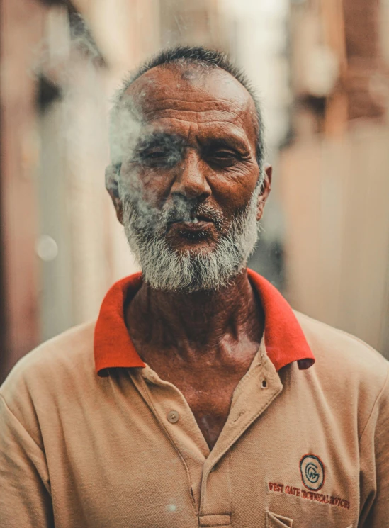 a man in a brown shirt and beard with red shirt