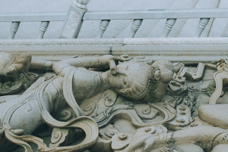 the sculpture on top of the building depicts a woman with two heads