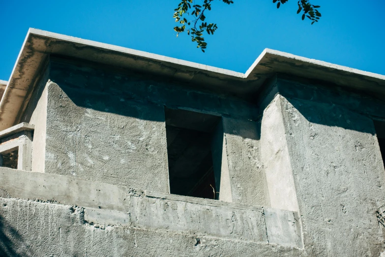 the side of a building with windows on a sunny day