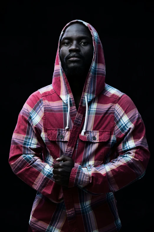 a man standing wearing a red checkered jacket