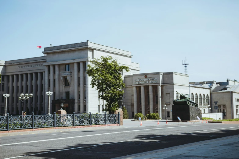 a building with tall columns sitting behind a guard rail