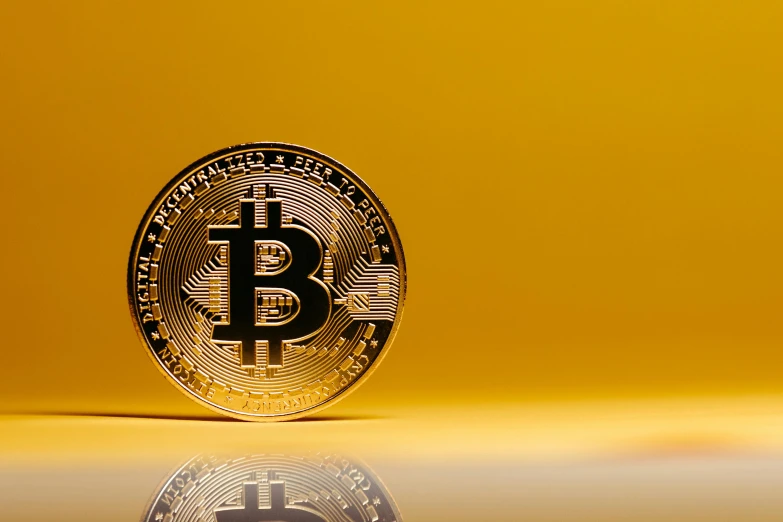 an image of a bit coin on yellow