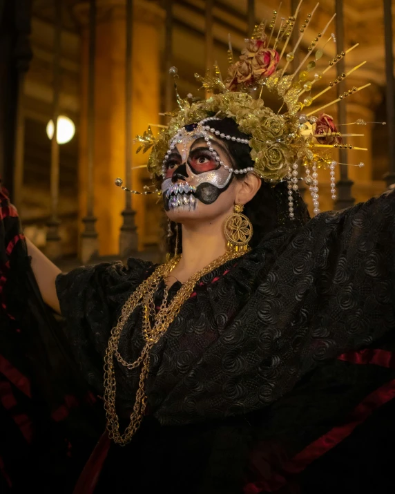 a woman with her hands in the air and some decorations on her face