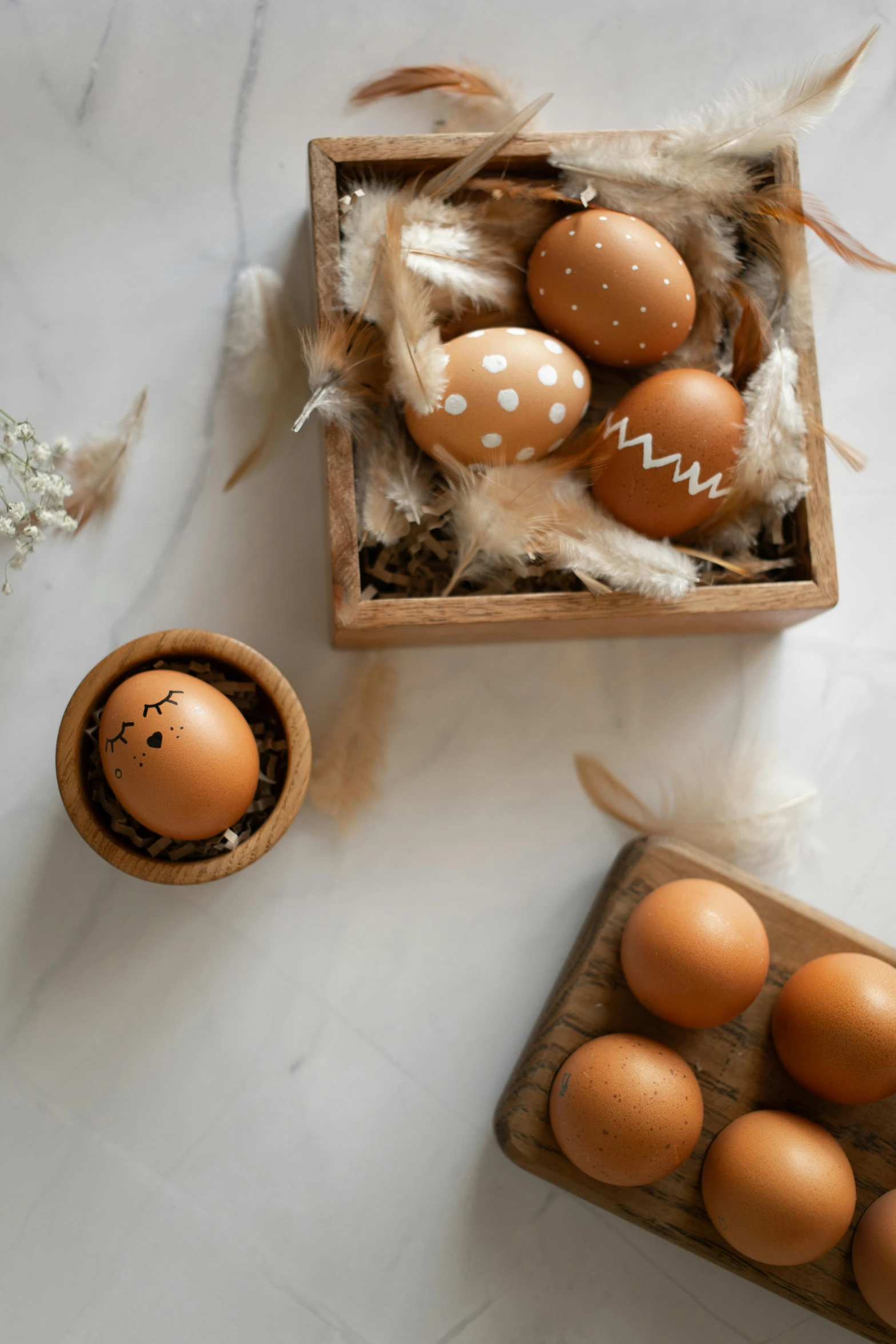 eggs are in a small wooden container next to an egg tray