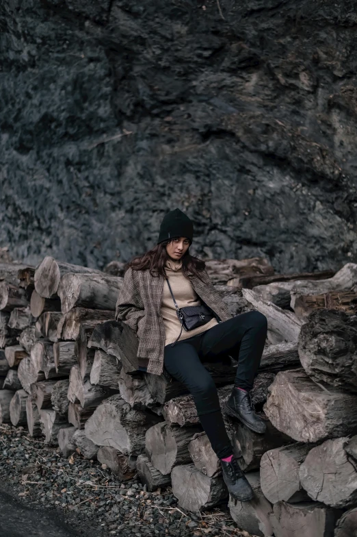 a woman sitting on a pile of rocks