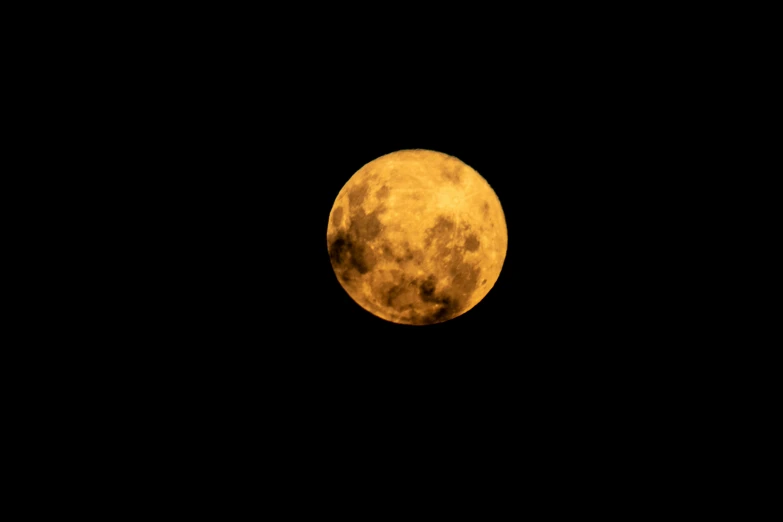 a view of a full moon from the dark night