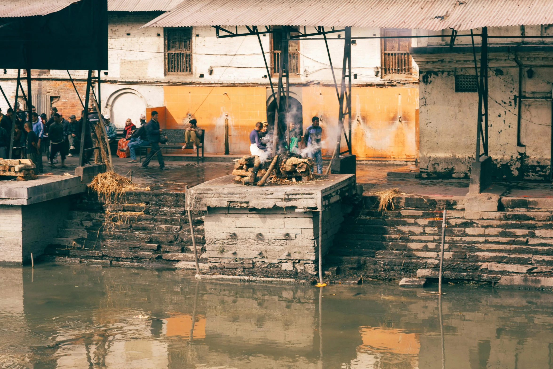 people in a village setting by the water