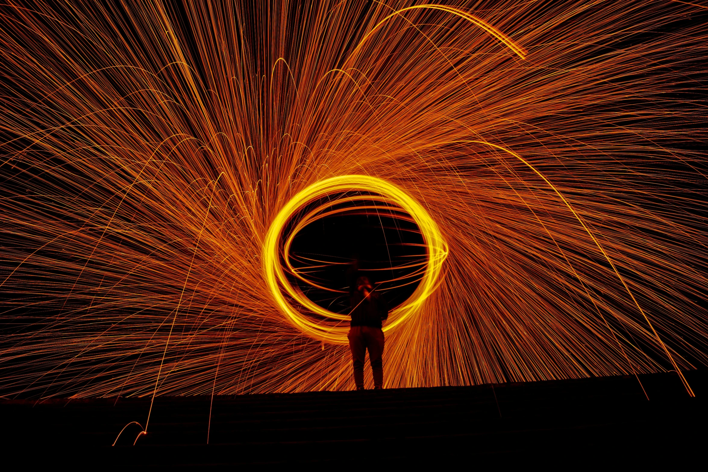 an artist standing on a building with a large ball of light around him