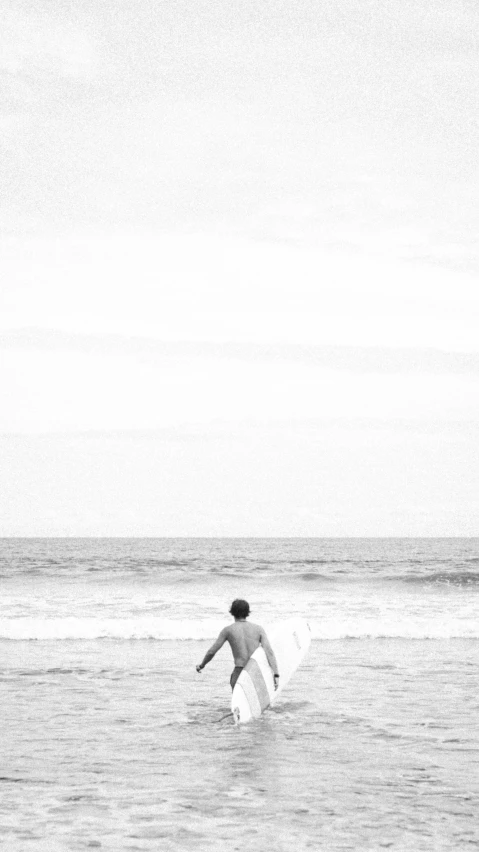 a surfer in a body of water with his board