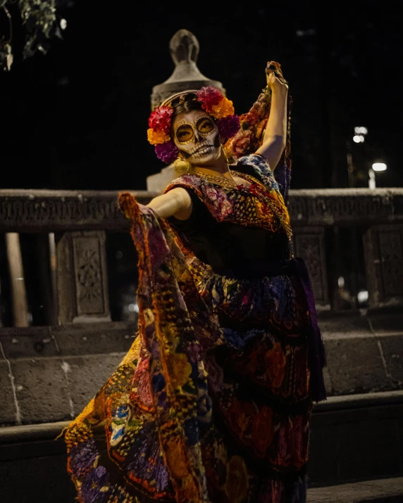 a woman with a sugar skull mask is doing an expression