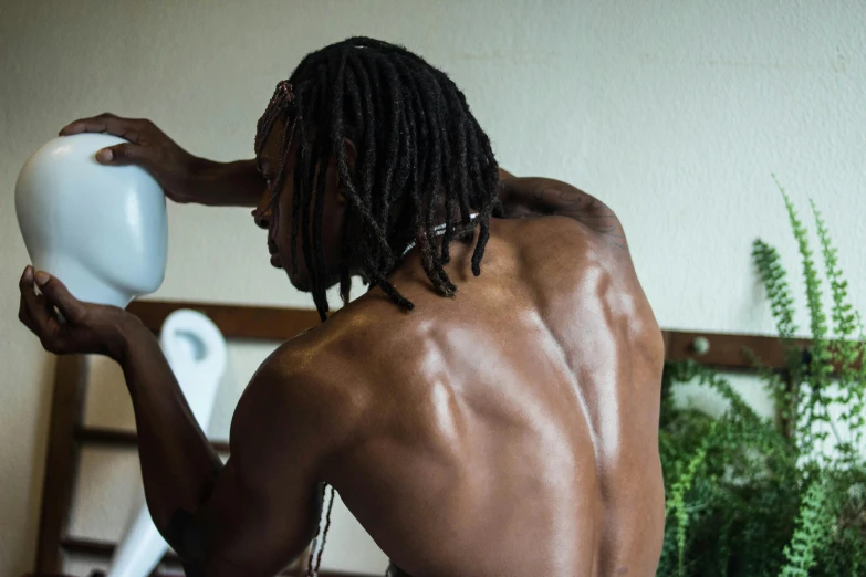 a  male holding onto a white object