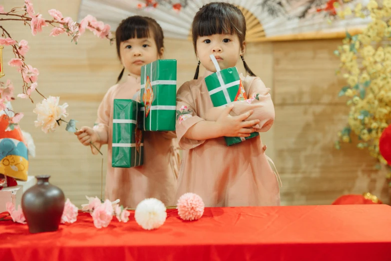 two girls are holding gifts in their hands