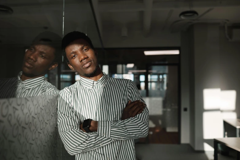 a couple of men standing next to each other in an empty room