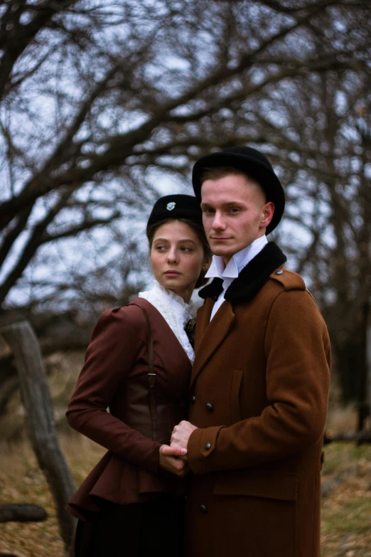 a man and a woman dressed in period clothes standing together