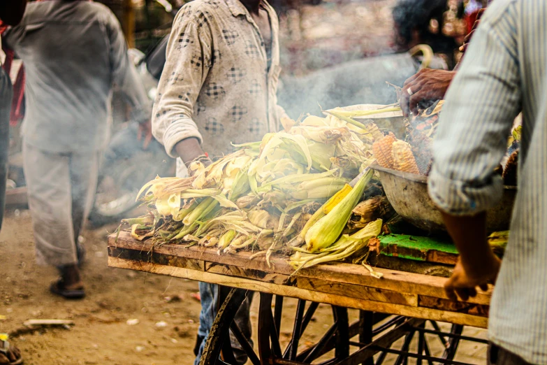 this is a man selling various kinds of vegetables