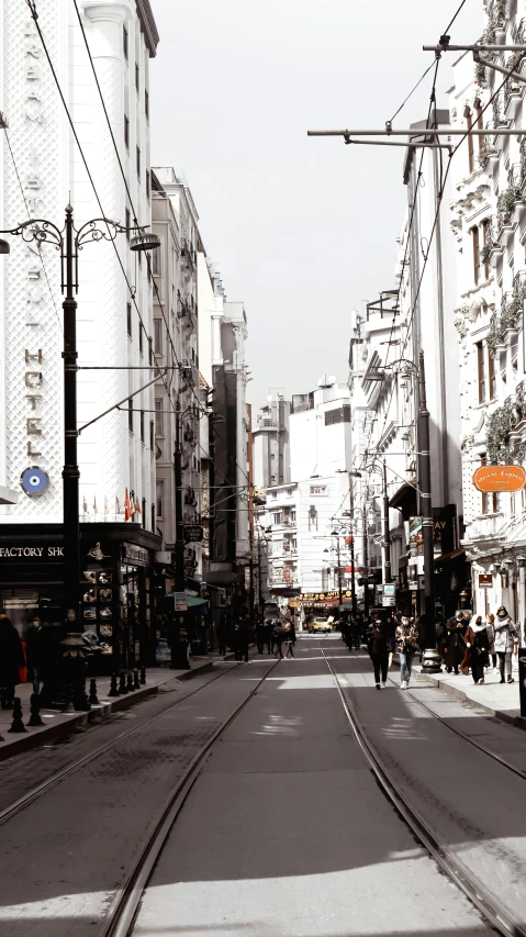 a city street with people walking and cars on the side