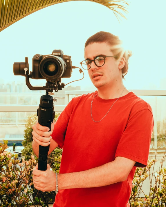 a person holding up a camera with a small device in front of them