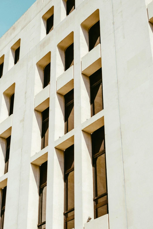 an architectural facade of a building with open windows