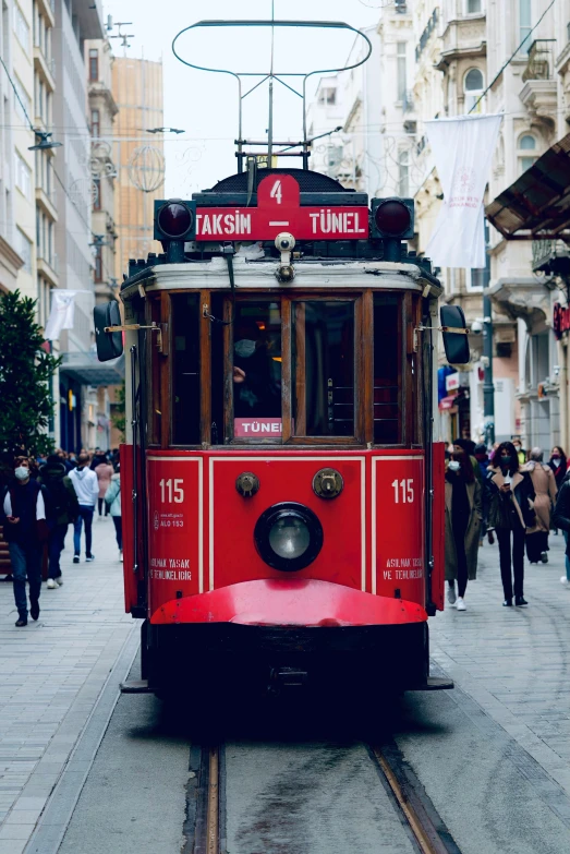 the red trolly is traveling through the streets of the old city