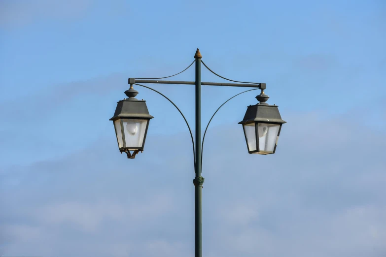 a lamp post sitting on the side of a street