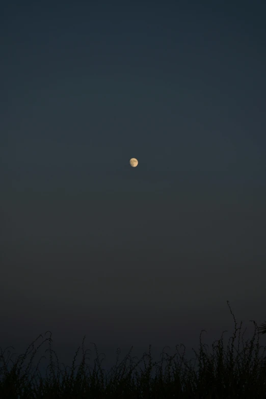 a distant view of the moon during the day