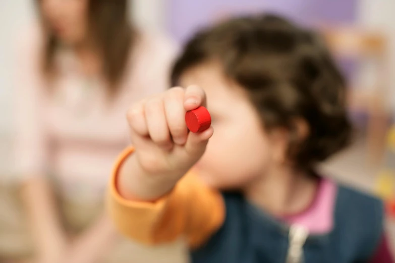 the small girl is pointing at the pographer