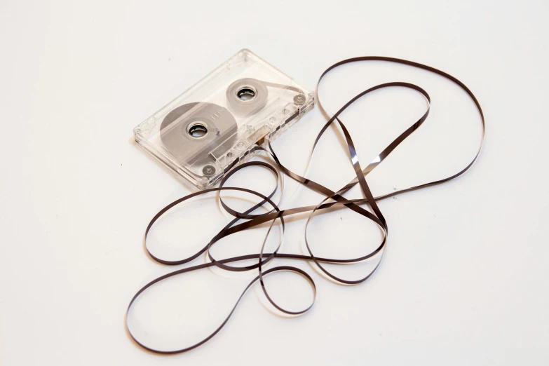 a pair of scissors laying next to a cassette tape