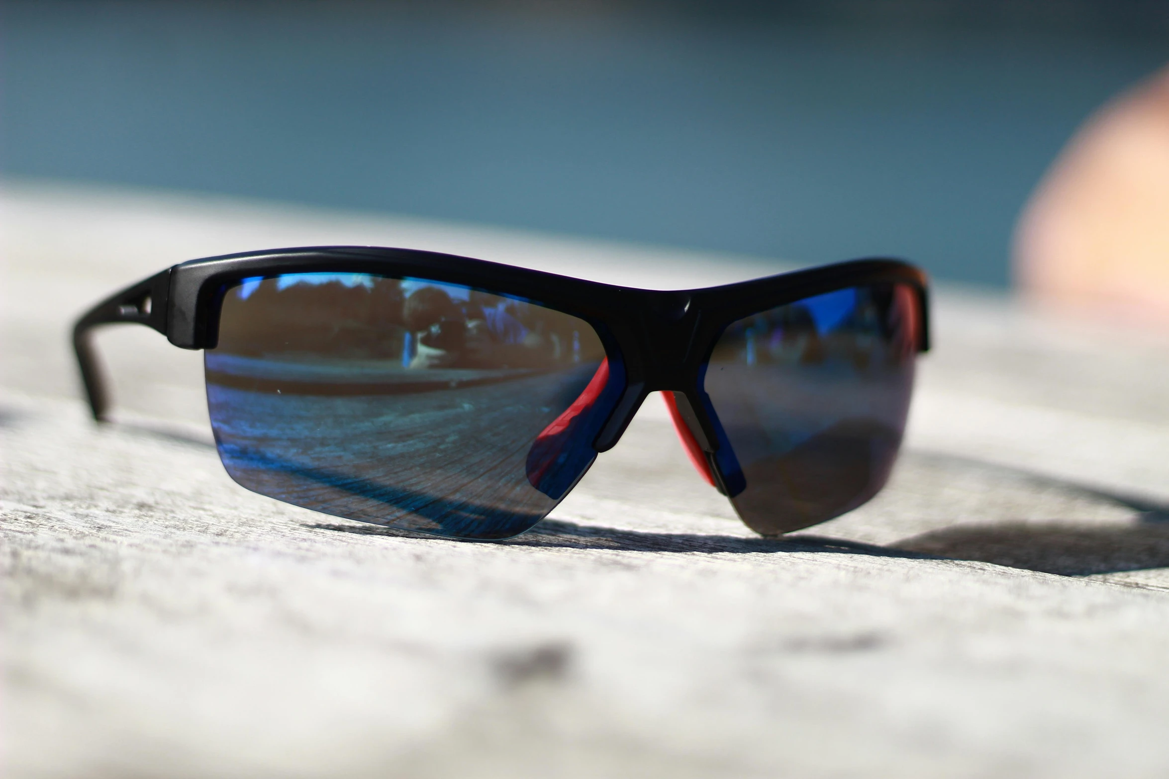 the reflection of the sunglasses on the pavement