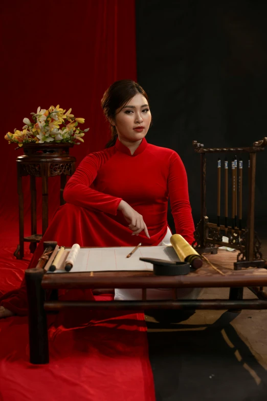 a woman in red sitting on a bench with a tray