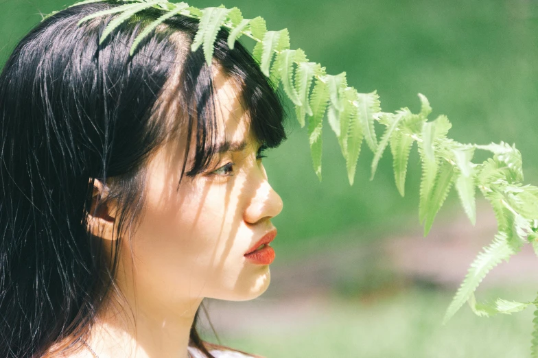 a girl with a long black hair and leaves in her head