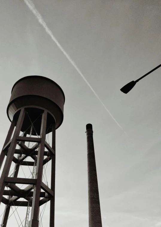 two large water towers near a street light