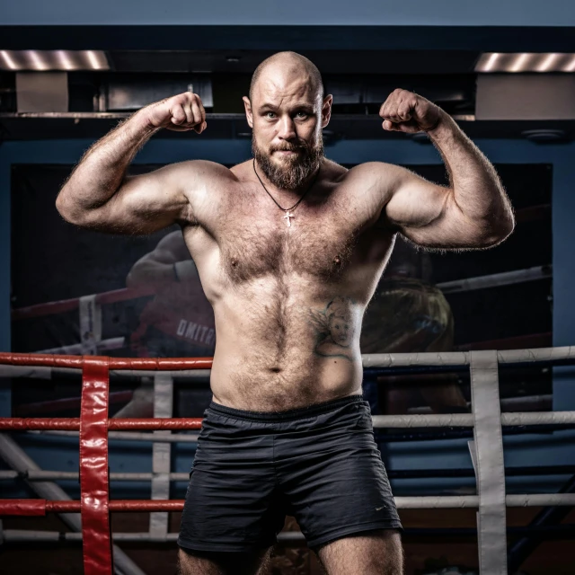 the man is wearing black boxers posing with one hand on his hips