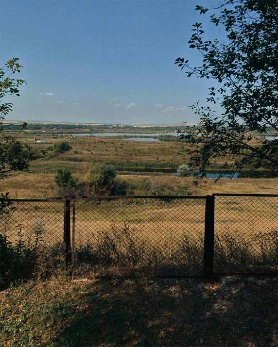 a po of an open, empty pasture from inside the fence