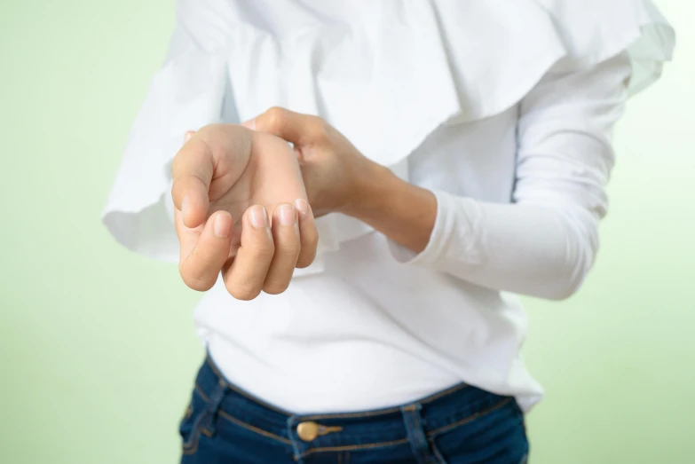 close up of two hands on the top half of her body