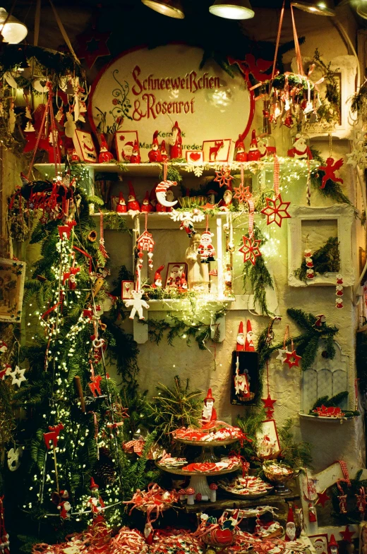 a store filled with many christmas ornaments in front of a sign