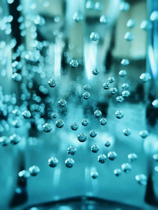 water drops coming out of the bottom of a glass bowl