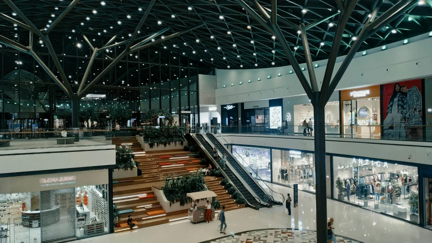 the interior of an indoor shopping mall with a stair case