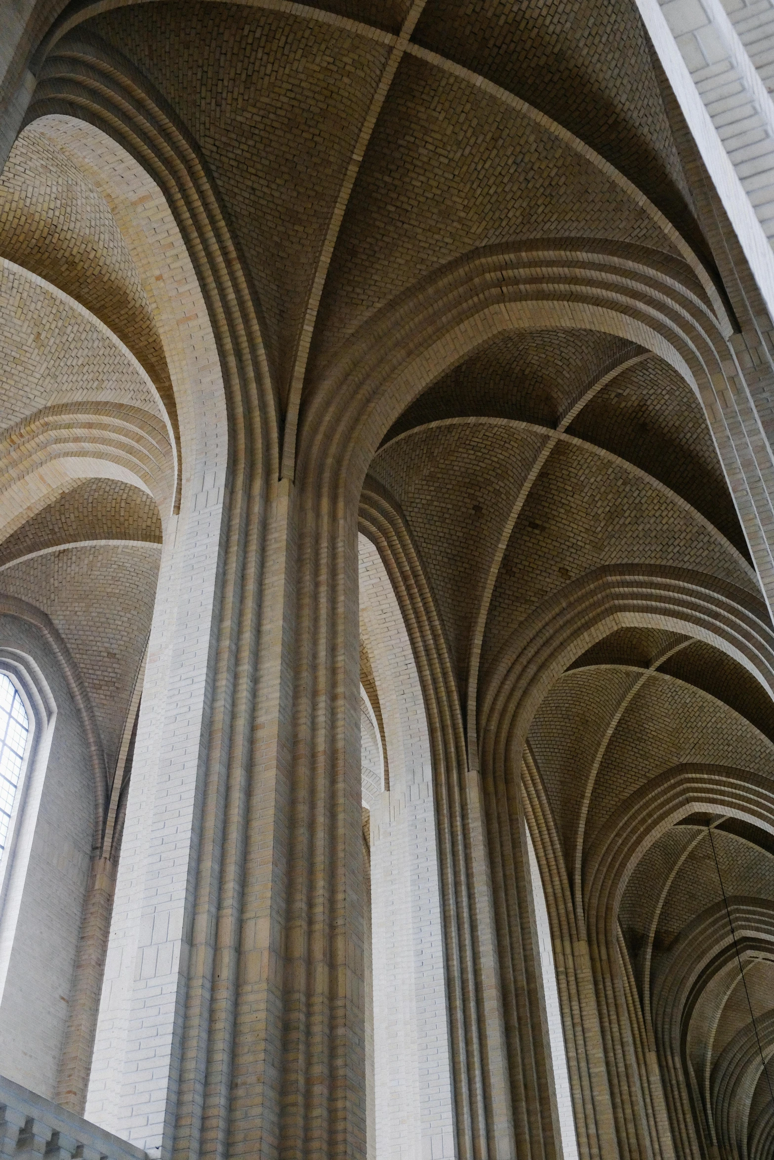 a very tall cathedral with arches and two benches