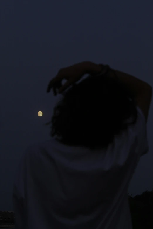 a man standing on top of a bridge at night