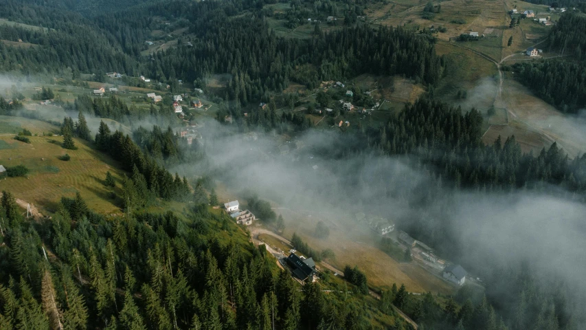 the view from above shows some fog hovering in front of a village